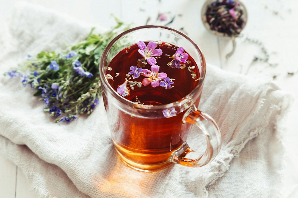 Herbal tea with blossoms in a glass