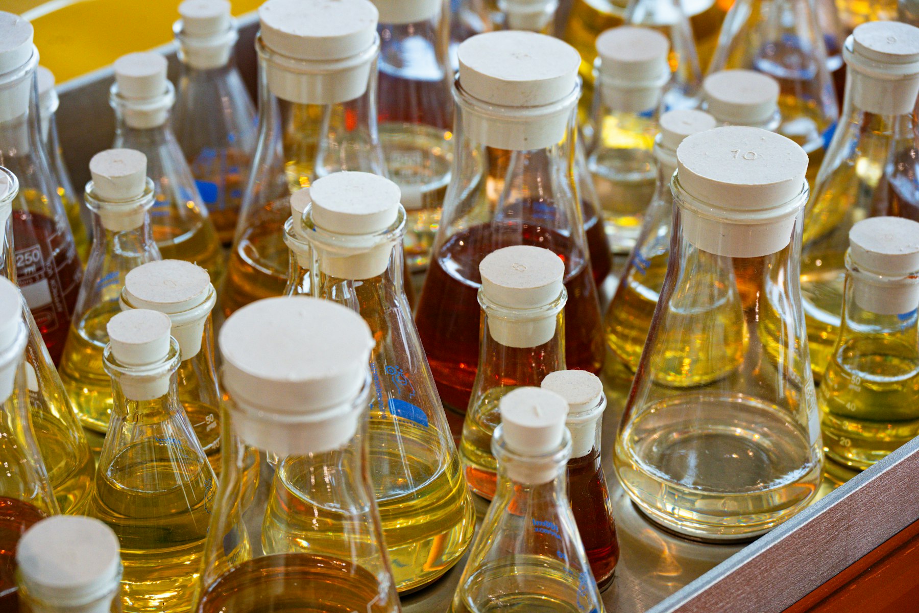 Glass bottles and flasks filled with colourful liquids